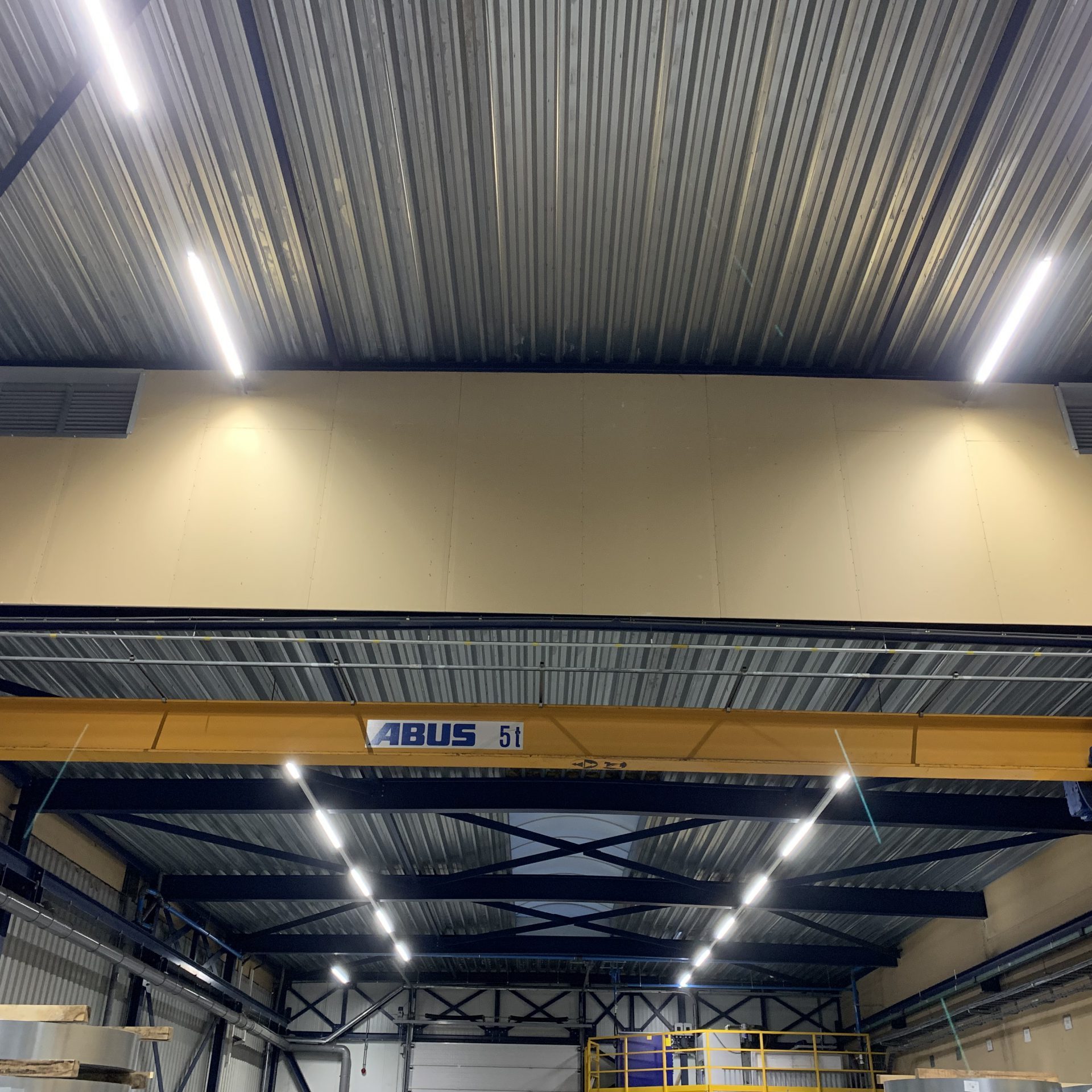 Industriële led lichtlijnen gemonteerd tegen een hoog en laag plafond